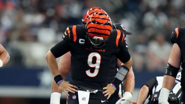 Cincinnati Bengals quarterback Joe Burrow (9) gets up slowly and looks down at this foot after a sack in the third quarter of an NFL Week 2 game against the Dallas Cowboys, Sunday, Sept. 18, 2022, at AT&T Stadium in Arlington, Texas. The Dallas Cowboys won, 20-17. Nfl Cincinnati Bengals At Dallas Cowboys Sept 18 2435